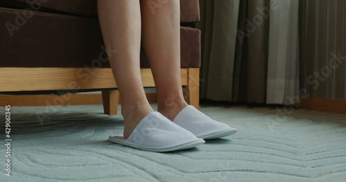 Woman wear slipper at hotel room photo