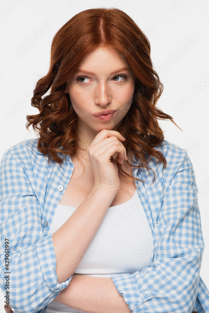 pensive redhead woman in blue shirt looking away isolated on white. pensive redhead woman in blue shirt looking away isolated on white.