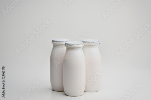 Bottles of liquid yogurt isolated on a white background.Concept - dairy products contain probiotic bacteria. Dietary supplements in bottles. Vitamins Sale of probiotics. 