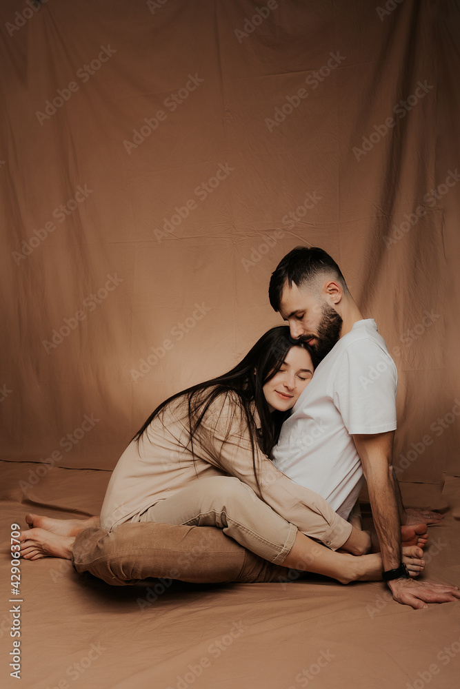 Image of young happy man kissing and hugging beautiful woman