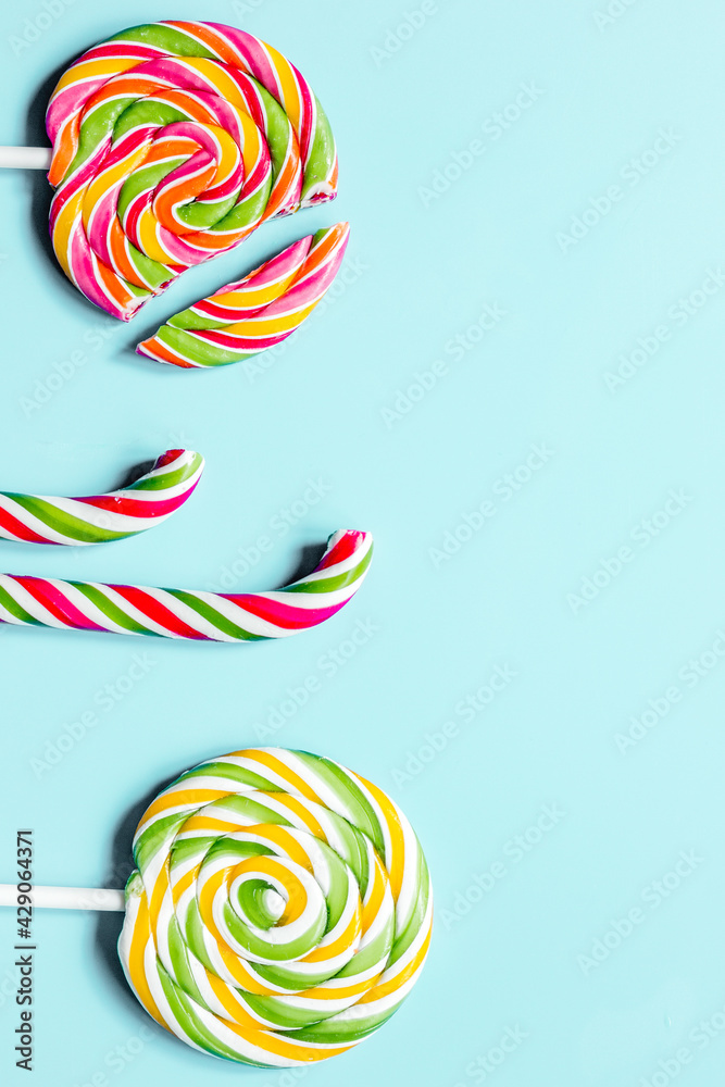 Colorful candies on blue texture background top view mock up