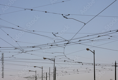 The network of electric cables supplying trams in the square in Lisbon.