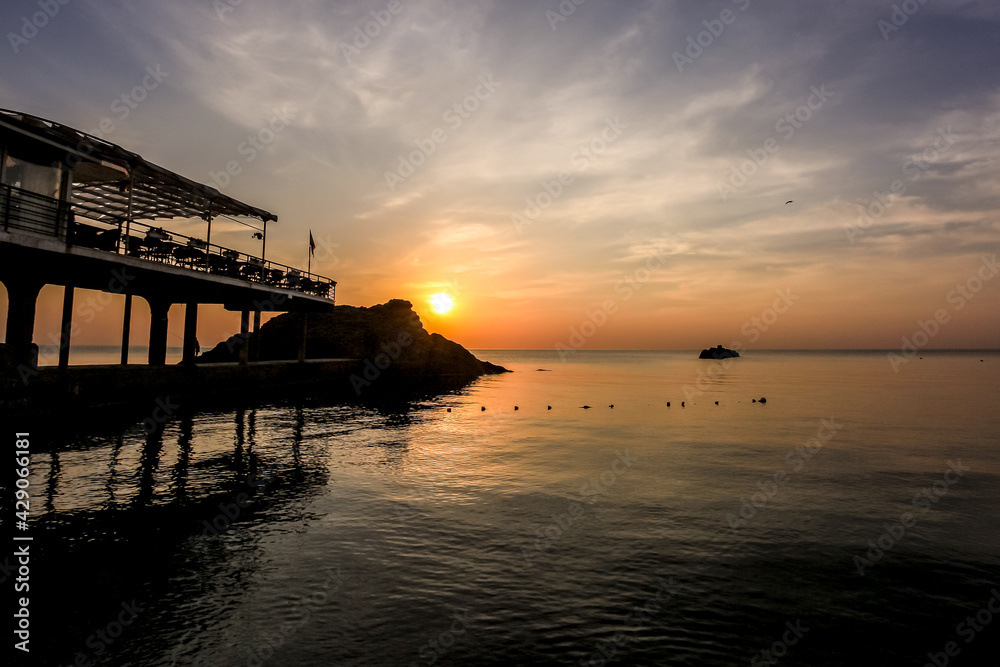 Beautiful sunrise in the Crimea. The village of Utes. The glare of the sun. A trick of the light. Summer morning by the Black Sea.