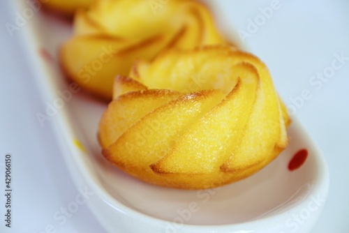 Salty muffin with cheese and corn flour on white plates