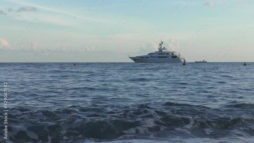 Low angle view of modern yacht near sea horizon in the evening.