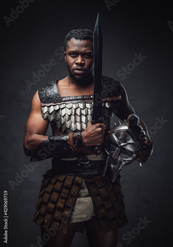 Studio shot of fearful authentic gladiator of african descent with gladius © Fxquadro