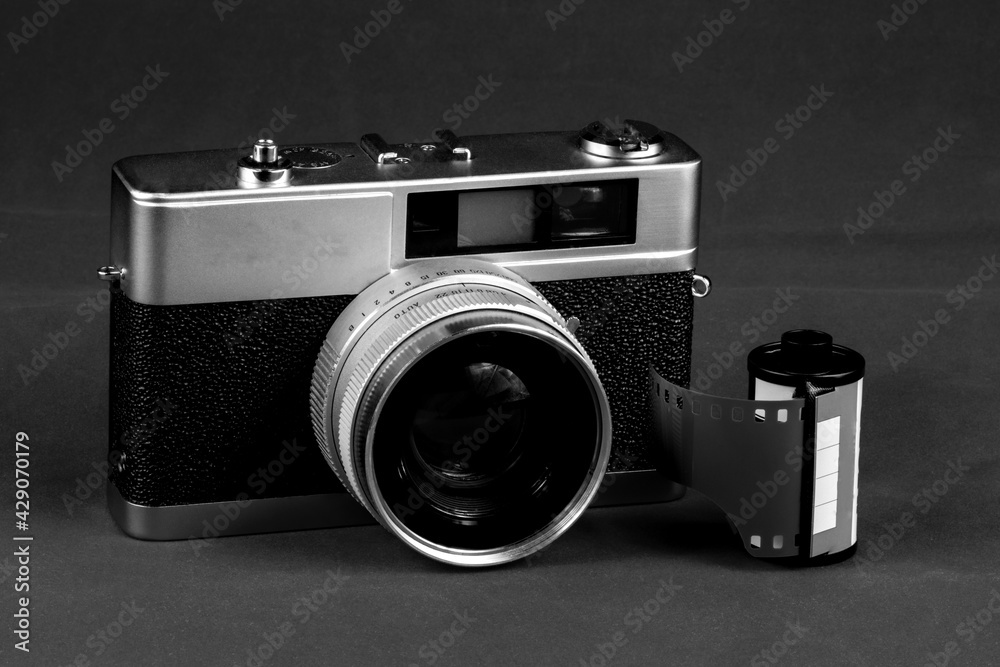 Monochrome Vintage Film Camera with Roll of Film