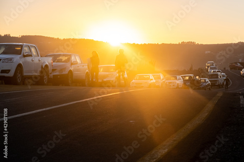 two surfers walking towards the sea, during a sunrise in pichilemu punta de lobos chile photo