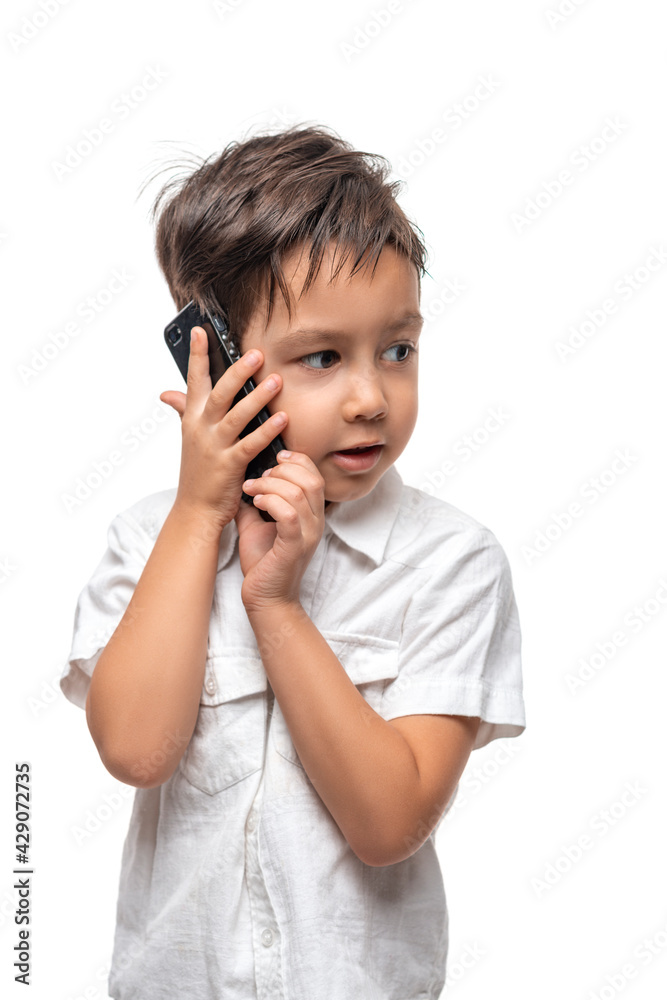 Little smiling boy talkes on the phone, isolated Little smiling boy talkes on the phone, isolated