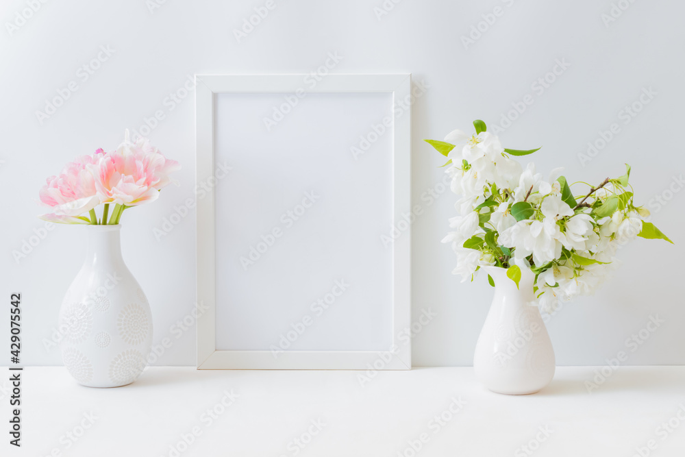 Mockup with a white frame and pink tulips in a vase on a light background