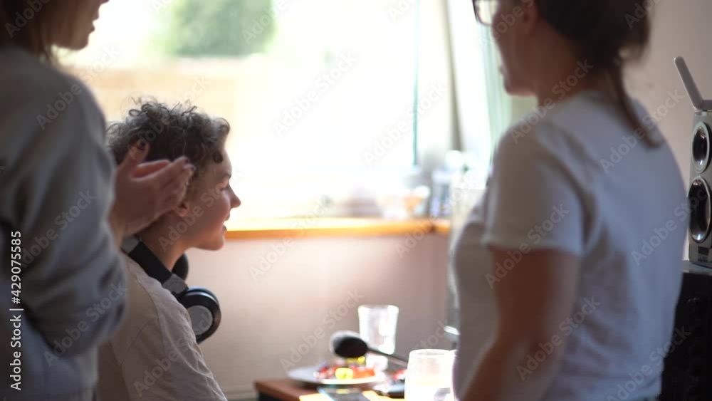Lesbian couple have problems with their teenage son. Adoption concept. Two women in a teenager's room are talking to a boy Lesbian couple have problems with their teenage son. Adoption concept. Two women in a teenager's room are talking to a boy