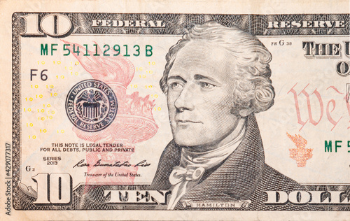 Close-up 10 US dollar banknotes, obverse ten dollar banknote depicting portrait American statesman Alexander Hamilton. © Sergio 