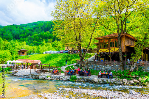 View of an outdoor restaurant situated on shore of a creek in Bulgaria. photo