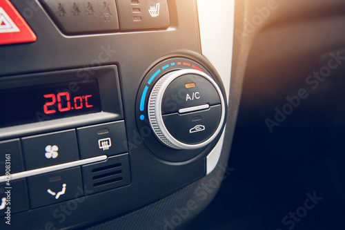 Switcher of air conditioning in the car. Button to turning on car climate control system. Close up view with selective focus.