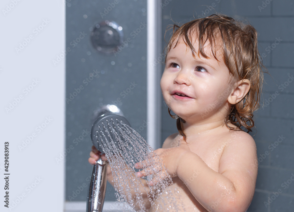 Child bathing under a shower. Washing adorable baby in bathroom. Kid ...