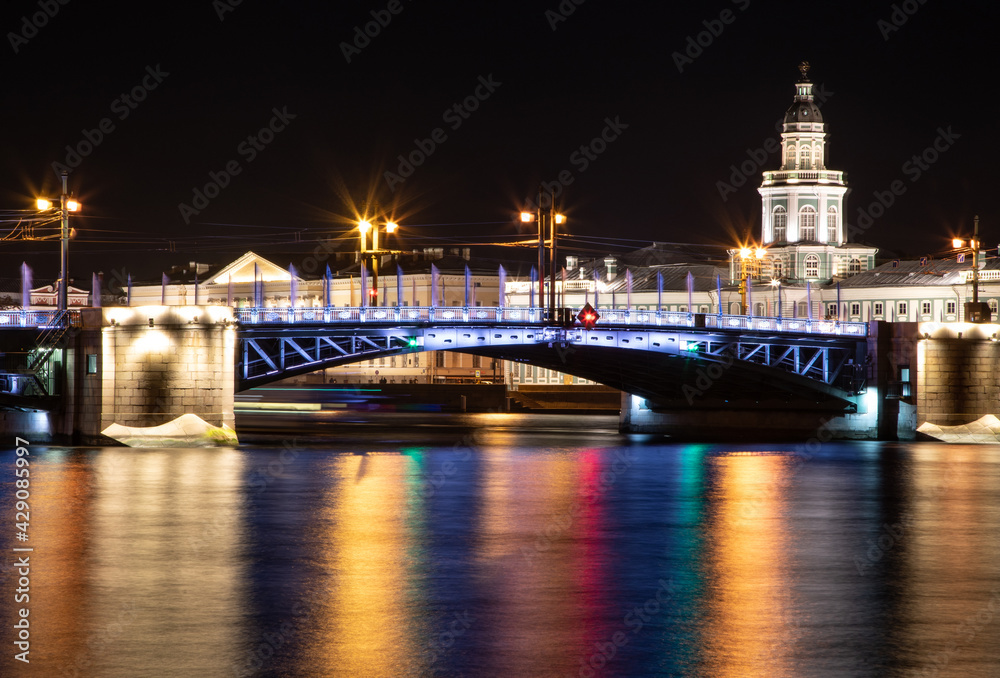 Laying bridges in St. Petersburg. Night city of Russia. Neva River. Reflection of colored lights in the water. Long-term exposure.