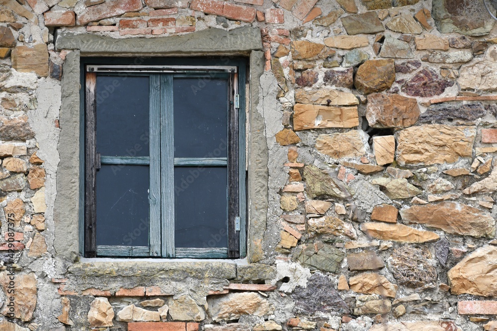 window of old abandoned and dilapidated stone house in the Tuscan countryside in Italy
