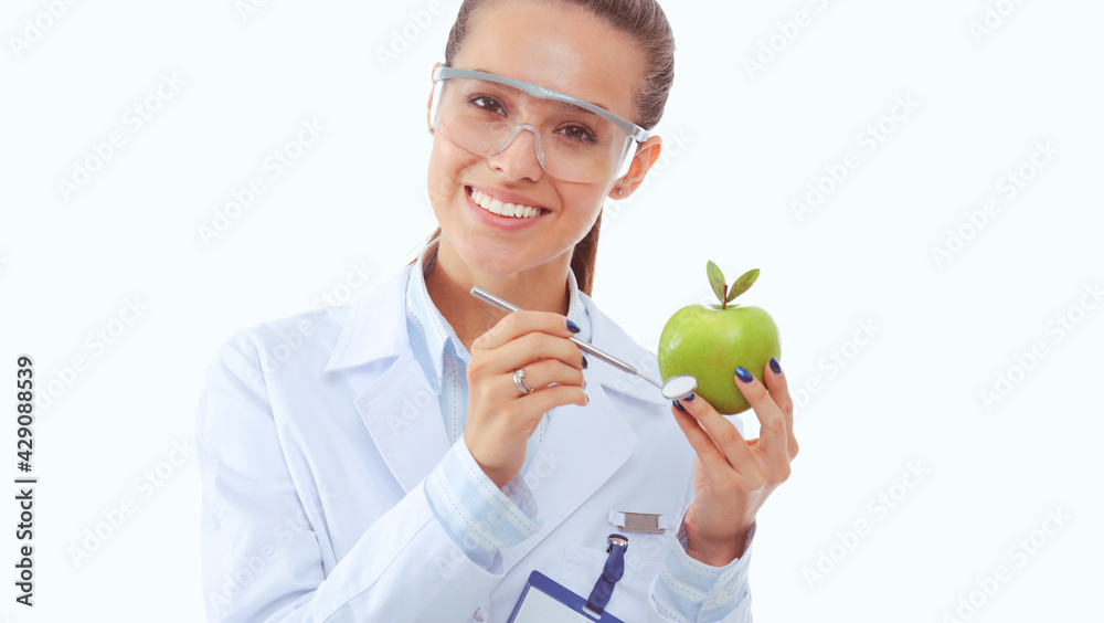 Smiling woman doctor with a green apple. Woman doctor Smiling woman doctor with a green apple. Woman doctor