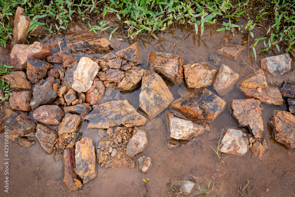Background of Many Stones of Different Sizes on the Wet Ground Background of Many Stones of Different Sizes on the Wet Ground