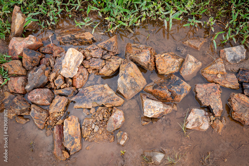 Background of Many Stones of Different Sizes on the Wet Ground