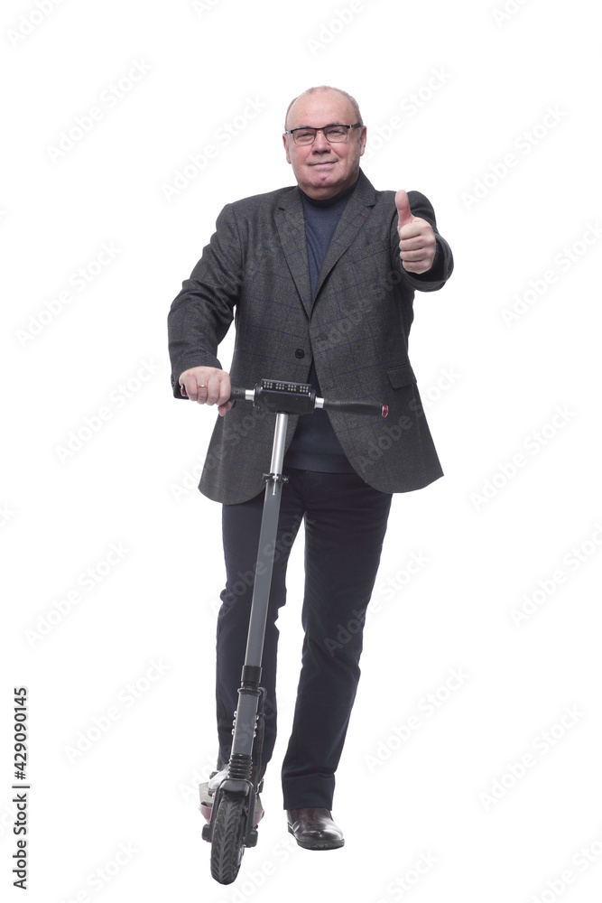 full growth . Mature business man with an electric scooter full growth . Mature business man with an electric scooter