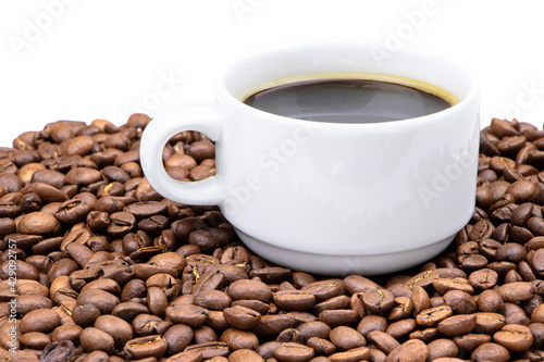 Coffee beans and cup of coffee isolated.Roasted coffee beans texture.Morning coffee