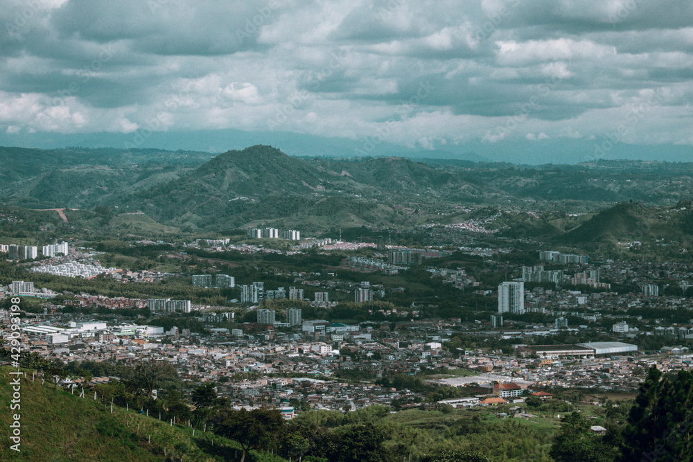 view of the city with mountains and clouds