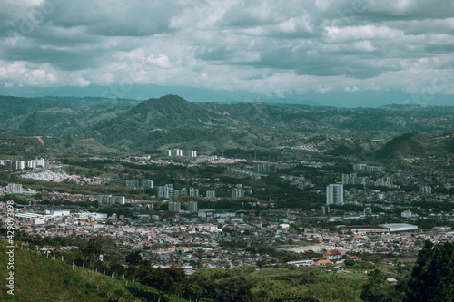 view of the city with mountains and clouds