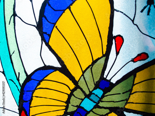 Stained Glass. Butterfly detail in colorful vitreaux backgound photo