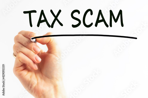 hand writing inscription tax scam with marker, concept, stock image