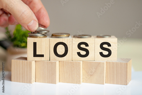 loss letters written on wooden toy blocks, business concept