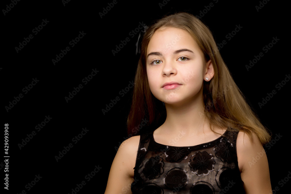 Close-up.Portrait of a cute little girl on a black background. Close-up.Portrait of a cute little girl on a black background.