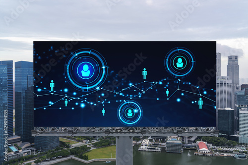 Glowing Social media icons on road billboard over panoramic city view of Singapore, Southeast Asia. The concept of networking and establishing new connections between people and businesses.