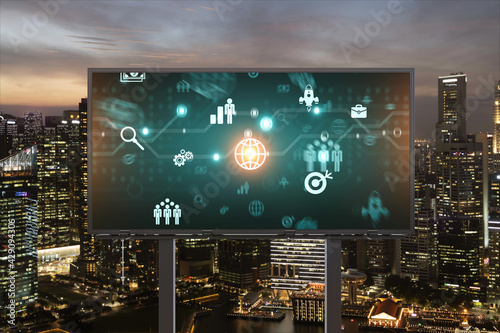Research and technological development glowing icons on billboard. Night panoramic city view of Singapore. Concept of innovative activities expanding new services or products in Southeast Asia.