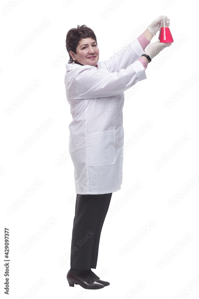 side view. a medical woman looking at a bottle of red liquid. side view. a medical woman looking at a bottle of red liquid.