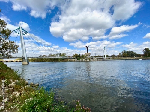 Wichita, Kansas: The Keeper of the Plains is a 44-foot, 5-ton weathered steel sculpture by Kiowa-Comanche artist Blackbear Bosin at the confluence of the Arkansas and Little Arkansas rivers. photo