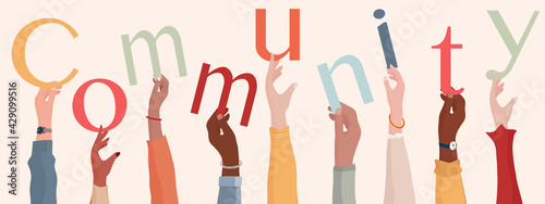 Group of raised hands holding the text Community. People diversity.Teamwork or community cooperation concept. Connection between diverse people.Communication and sharing.Racial equality
