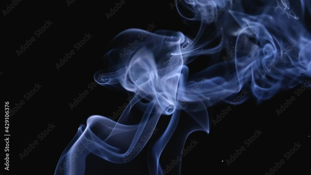Abstract white smoke in slow motion. White smoke, a cloud of cold fog on a black background. Close up.