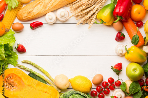 Fototapeta Naklejka Na Ścianę i Meble -  Vegetables, fruits assortment frame on white wooden background. Farmer table. Vegetarian healthy food concept. Food and grocery shopping. Free space