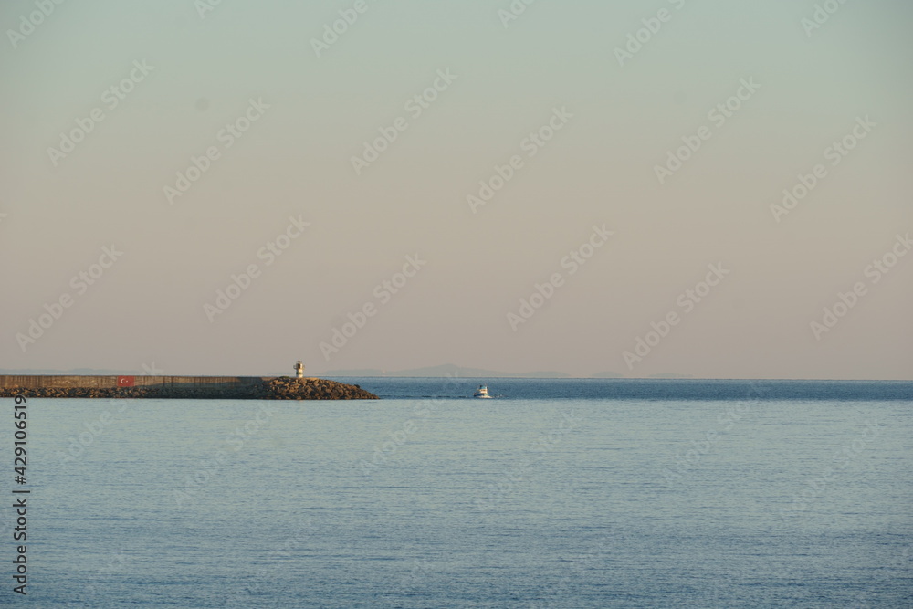 Small boat cruising near the lighthouse