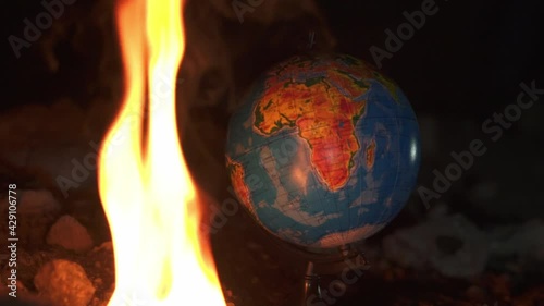 Wallpaper Mural Close up of fire burning near globe on destructed floor with a lot of rocks. Bright fire with a lot of smoke above view Torontodigital.ca