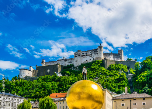 the festung Hohensalzburg fortress with the Sphaera sculpture situated on the Kapitelplatz in the central Salzburg, Austria.