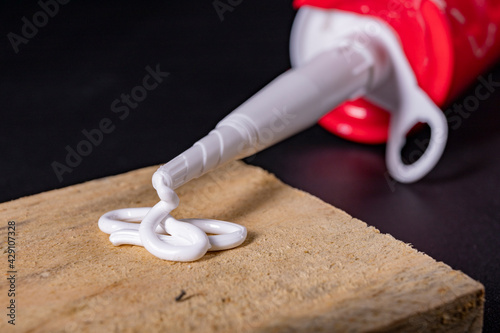 Silicone leaking from the plastic tube. A material for sealing in a domestic bathroom. photo