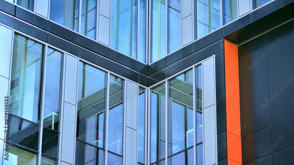 Obraz premium The glazed facade of an office building with reflected sky. Modern architecture buildings exterior background. Clouds sky reflection.
