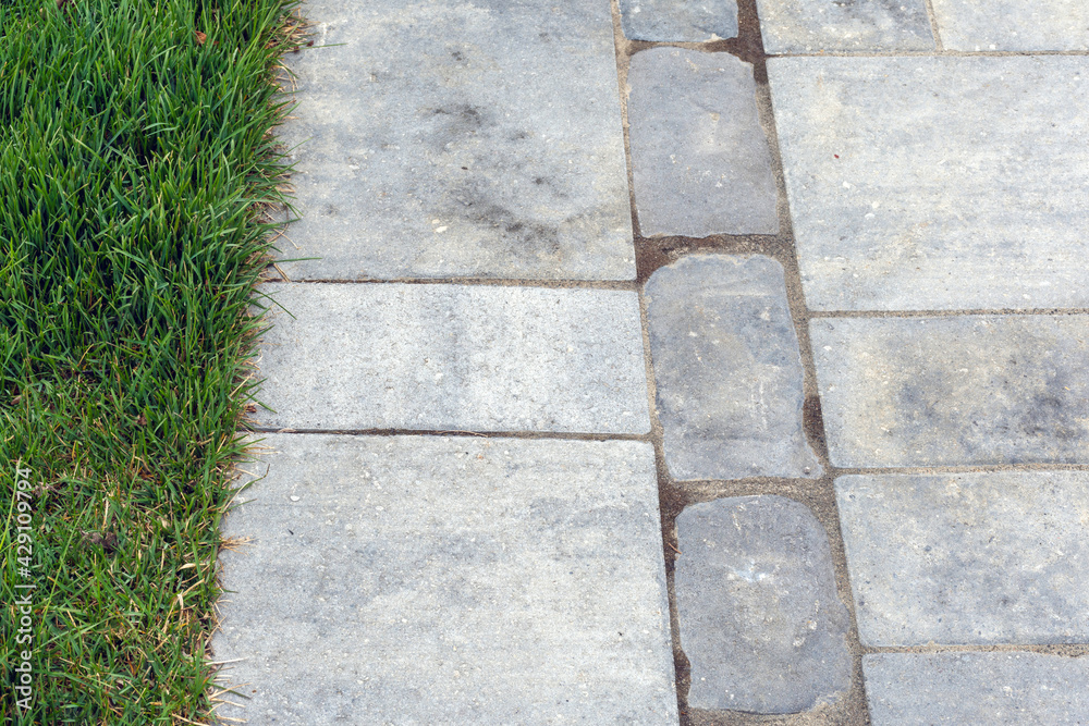 Closeup detail of luxury driveway hardscape with pavers and pattern banding.