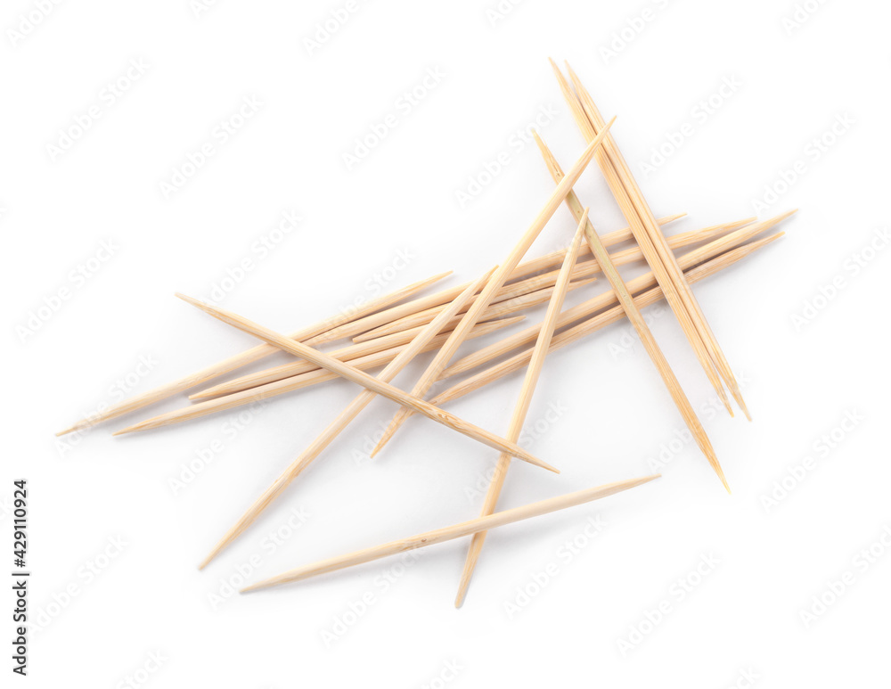 Heap of wooden toothpicks on white background, top view Heap of wooden toothpicks on white background, top view