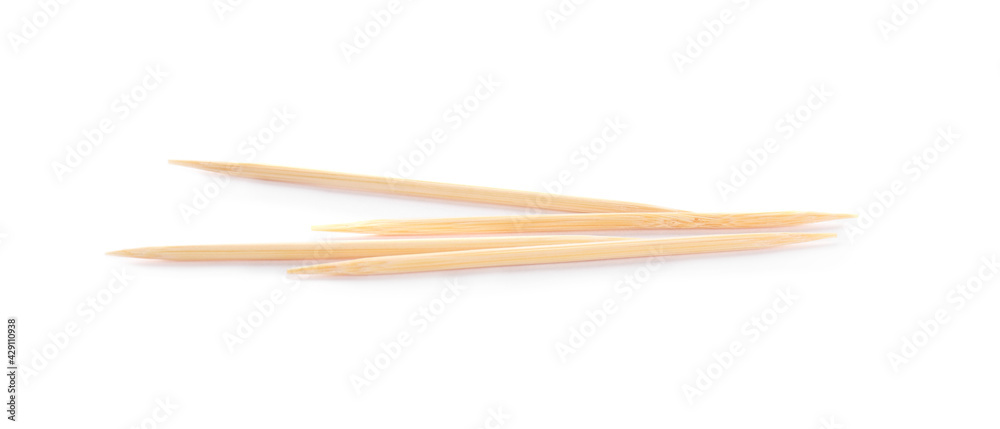 Four disposable wooden toothpicks on white background Four disposable wooden toothpicks on white background