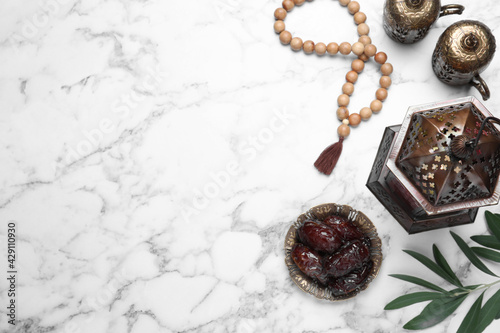 Flat lay composition with Arabic lantern on white marble table . Space for text photo