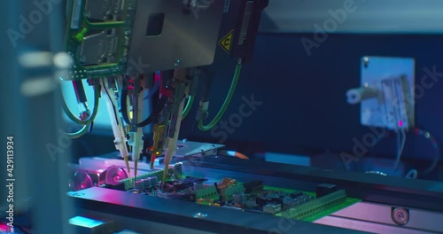 Modern industrial electronics manufacturing equipment makes a complex printed circuit board.High-tech production close-up.