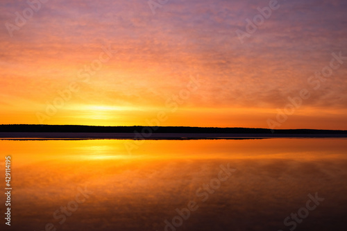 Sunrise over mirror calm lake